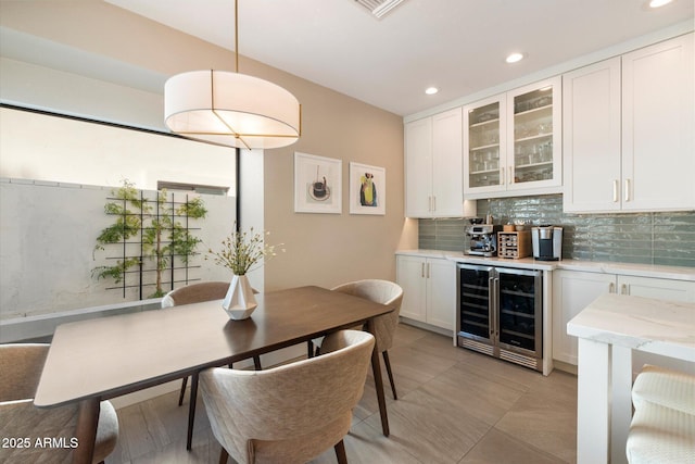 9915 E Cinnabar Ave, Scottsdale, AZ 85258 - dining area with a dry bar, wine cooler, visible vents, and recessed lighting