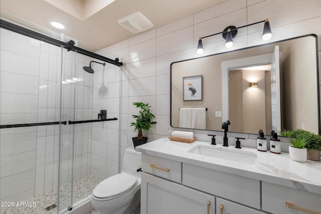 9915 E Cinnabar Ave, Scottsdale, AZ 85258 - full bathroom with toilet, tile walls, a stall shower, visible vents, and vanity