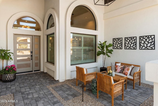 9915 E Cinnabar Ave, Scottsdale, AZ 85258 - doorway to property featuring outdoor lounge area, a patio area, and stucco siding