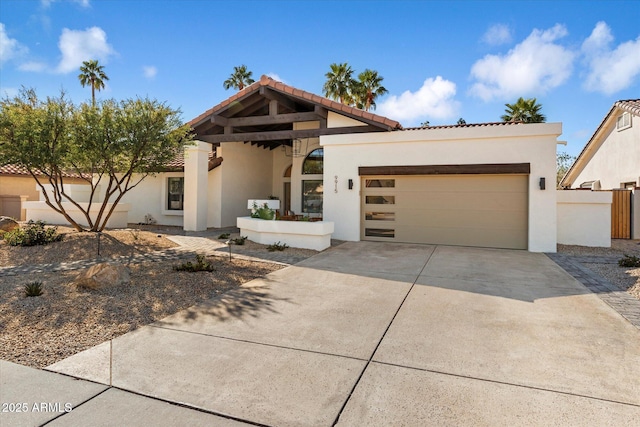 9915 E Cinnabar Ave, Scottsdale, AZ 85258 - view of front facade featuring stucco siding, a tile roof, driveway, and a garage