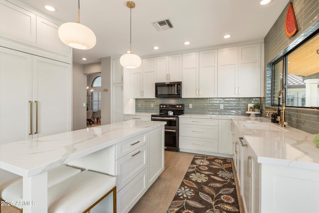 9915 E Cinnabar Ave, Scottsdale, AZ 85258 - kitchen with visible vents, a sink, backsplash, and range with two ovens