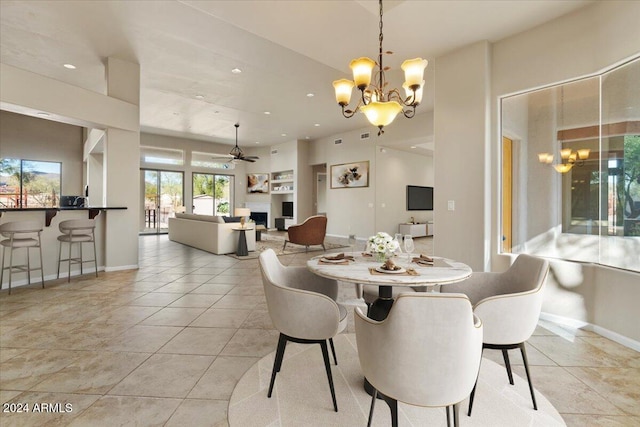 dining area with ceiling fan with notable chandelier