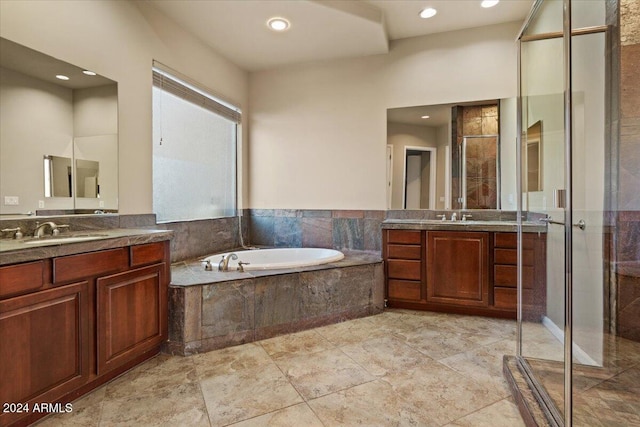 bathroom featuring plus walk in shower and vanity