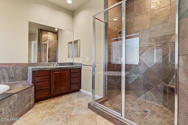 bathroom with vanity and separate shower and tub