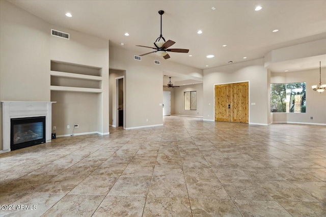 36908 N 19th St, Phoenix, AZ 85086 - unfurnished living room featuring a ceiling fan, built in features, recessed lighting, a glass covered fireplace, and a chandelier