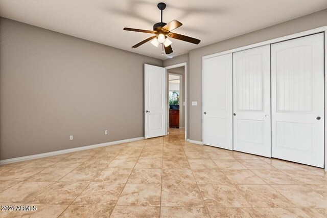 36908 N 19th St, Phoenix, AZ 85086 - unfurnished bedroom with a closet, baseboards, and a ceiling fan