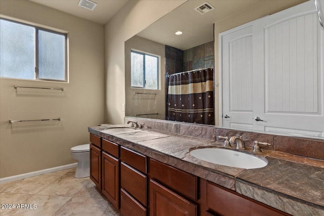 bathroom featuring tile patterned floors, vanity, a shower with shower curtain, and toilet