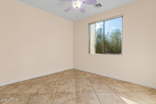 spare room featuring ceiling fan and light tile patterned floors