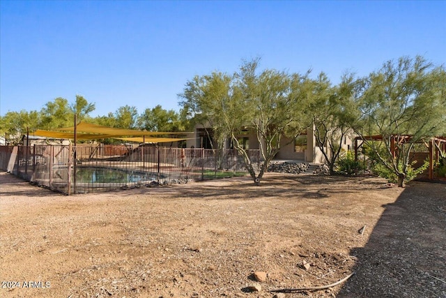 view of yard with a fenced in pool