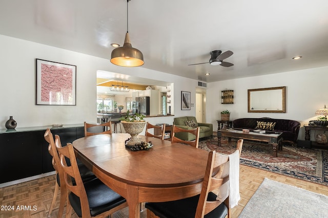 dining room featuring ceiling fan and parquet flooring