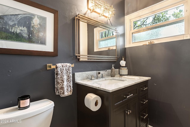 bathroom featuring toilet and vanity