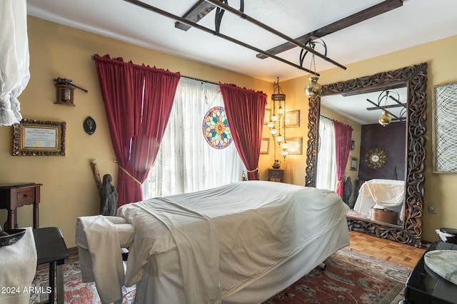 bedroom with multiple windows and parquet flooring