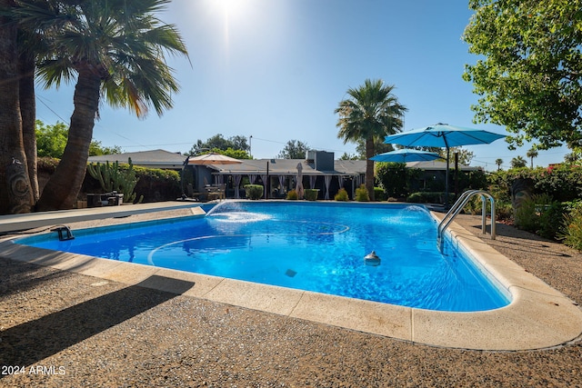 view of swimming pool with pool water feature