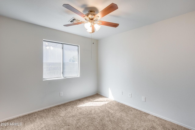 carpeted empty room with visible vents, baseboards, and ceiling fan