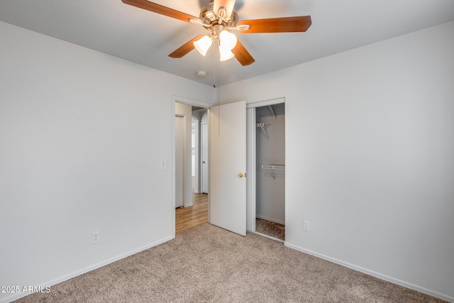 unfurnished bedroom featuring ceiling fan, baseboards, a closet, and light carpet