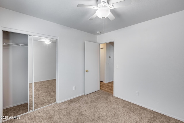 unfurnished bedroom with a closet, baseboards, a ceiling fan, and carpet