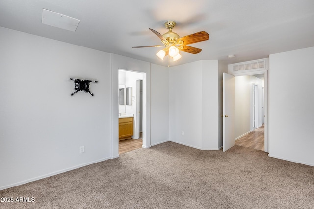 empty room featuring baseboards, light carpet, and ceiling fan