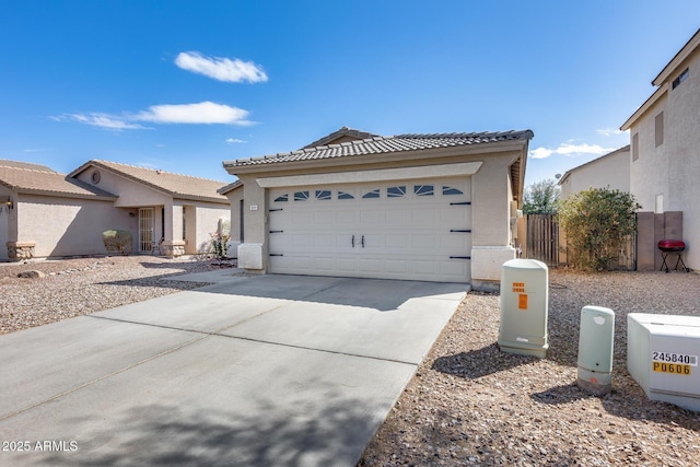 ranch-style home with stucco siding, a tiled roof, concrete driveway, and fence