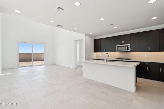 10253 E Ursula Ave, Mesa, AZ 85212 - kitchen with stainless steel microwave, black gas cooktop, dark cabinets, light countertops, and recessed lighting