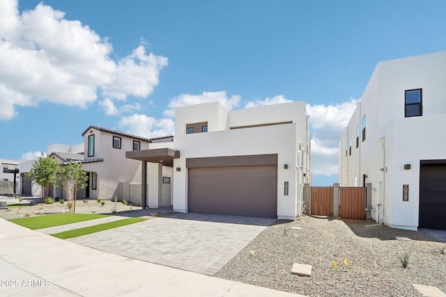 10253 E Ursula Ave, Mesa, AZ 85212 - contemporary home featuring stucco siding, decorative driveway, and a gate