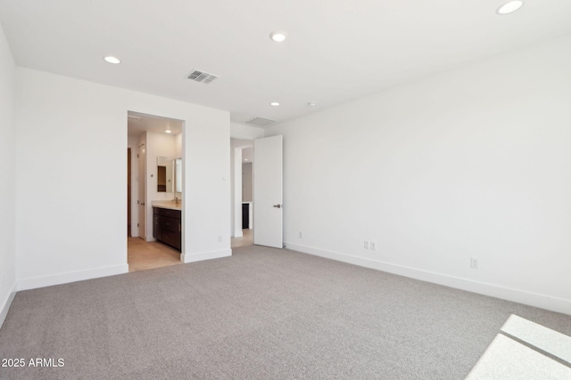 10253 E Ursula Ave, Mesa, AZ 85212 - unfurnished bedroom featuring recessed lighting, light colored carpet, baseboards, and connected bathroom