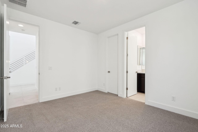 10253 E Ursula Ave, Mesa, AZ 85212 - unfurnished bedroom featuring light carpet, baseboards, and ensuite bath