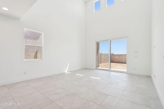 10253 E Ursula Ave, Mesa, AZ 85212 - empty room with light tile patterned floors, a towering ceiling, baseboards, and recessed lighting