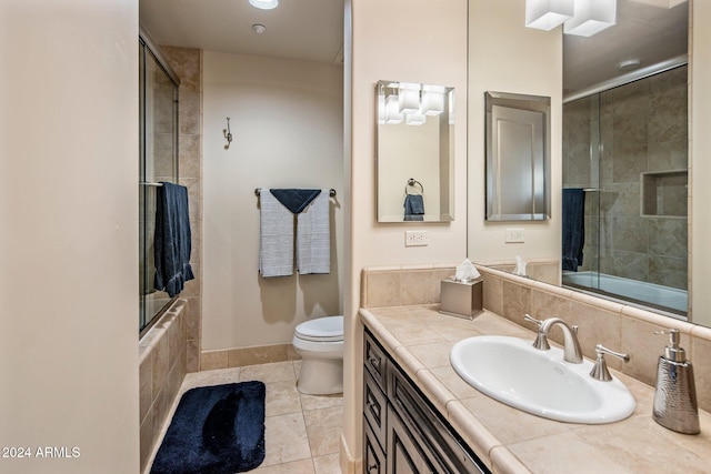 full bathroom with toilet, combined bath / shower with glass door, vanity, and tile patterned floors