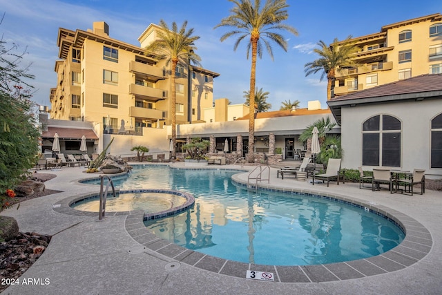 view of pool with a community hot tub and a patio