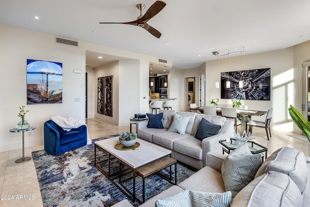 living room with light tile patterned floors and ceiling fan