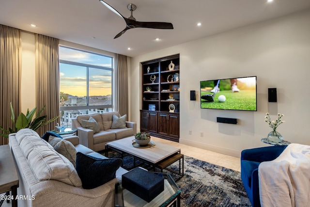 living room with built in features, light tile patterned floors, and ceiling fan