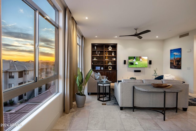 tiled living room with ceiling fan