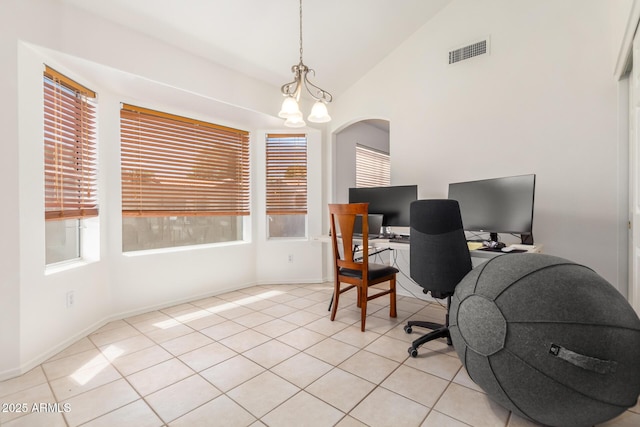 tiled office featuring a chandelier, vaulted ceiling, and a healthy amount of sunlight