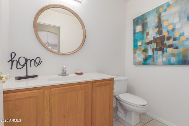 bathroom with tile patterned flooring, vanity, and toilet