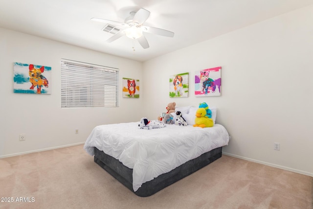 bedroom with ceiling fan and light carpet