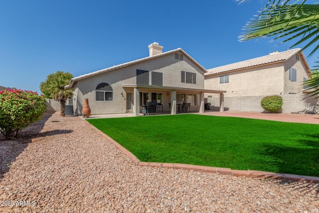 back of property featuring central air condition unit, a patio area, and a lawn