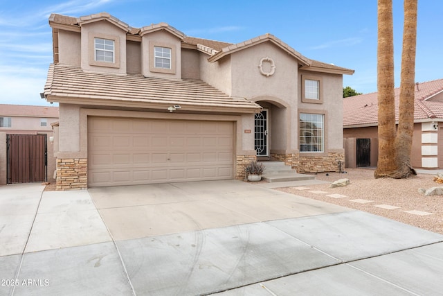 view of front of property with stone siding, stucco siding, driveway, and a gate