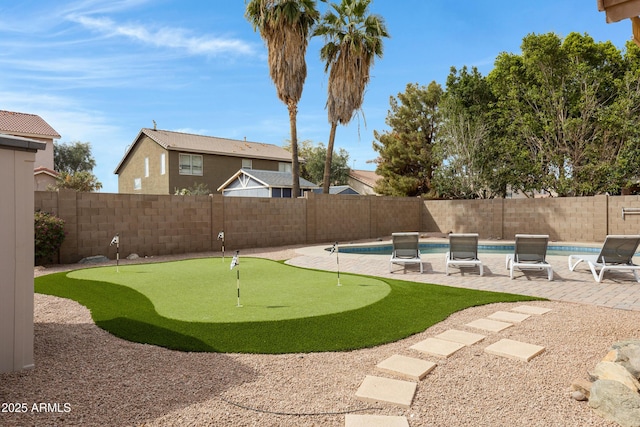 view of yard with a fenced in pool, a patio, and a fenced backyard