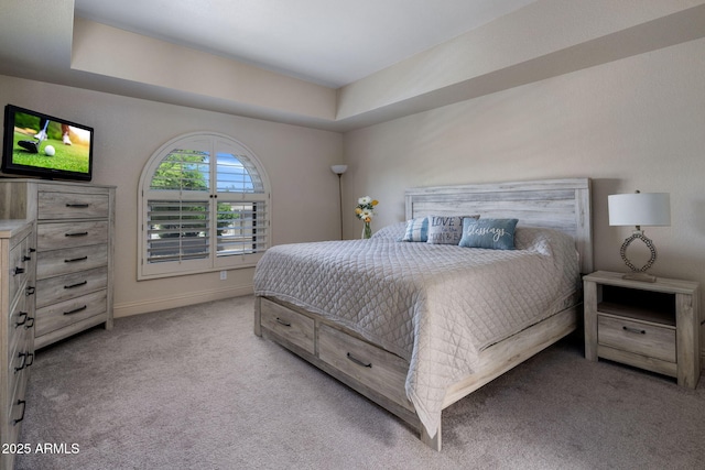 bedroom featuring light colored carpet and baseboards