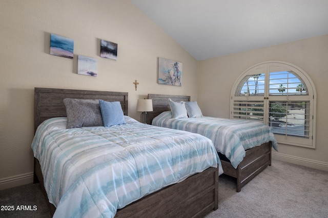 carpeted bedroom with baseboards and lofted ceiling