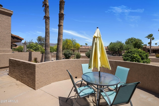 view of patio with outdoor dining area and fence