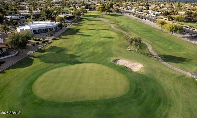 aerial view of property and surrounding area with a golf club and nearby suburban area