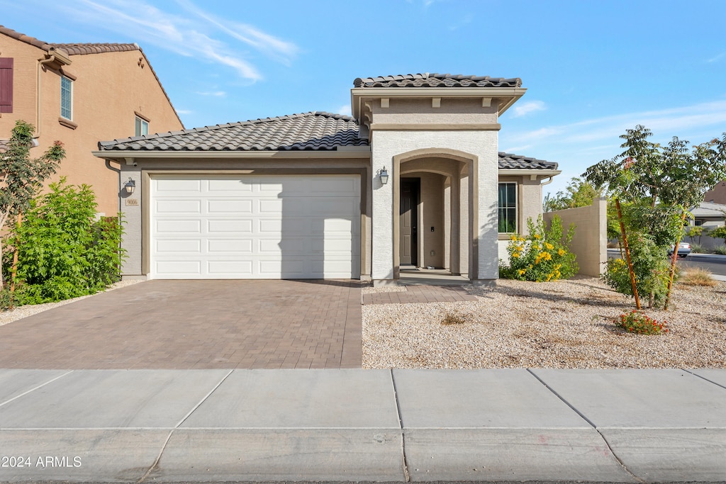 mediterranean / spanish house featuring a garage