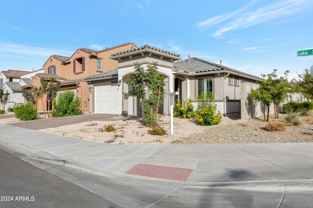 mediterranean / spanish-style home with a garage