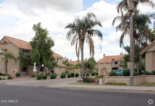 view of front facade featuring stucco siding and a residential view
