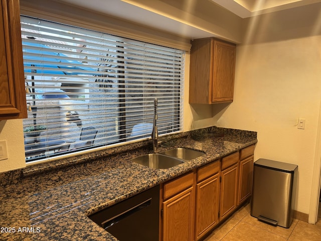1001 N Pasadena St Unit 162, Mesa, AZ 85201 - kitchen featuring dishwasher, a sink, light tile patterned flooring, dark stone counters, and brown cabinets