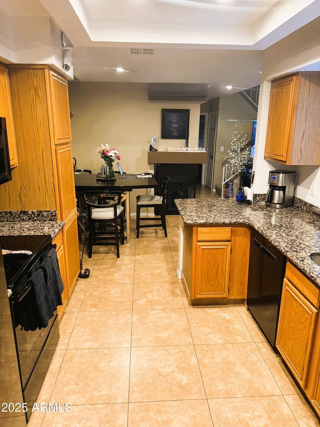 1001 N Pasadena St Unit 162, Mesa, AZ 85201 - kitchen featuring black appliances, a peninsula, dark stone counters, and light tile patterned floors