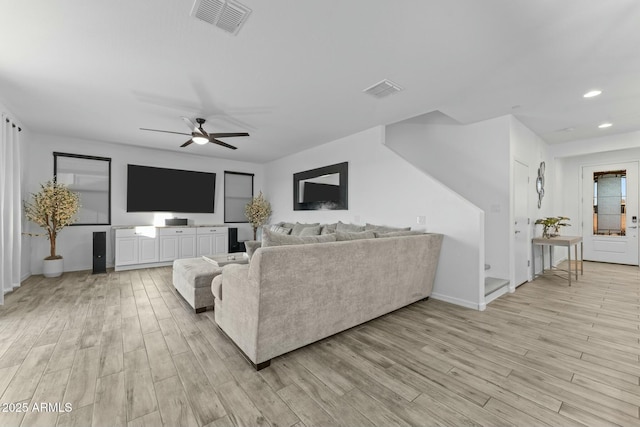 living room featuring light hardwood / wood-style floors and ceiling fan