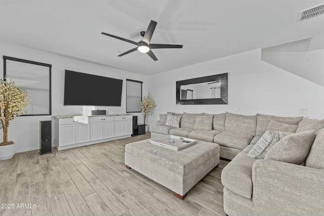 living room featuring ceiling fan and light hardwood / wood-style floors