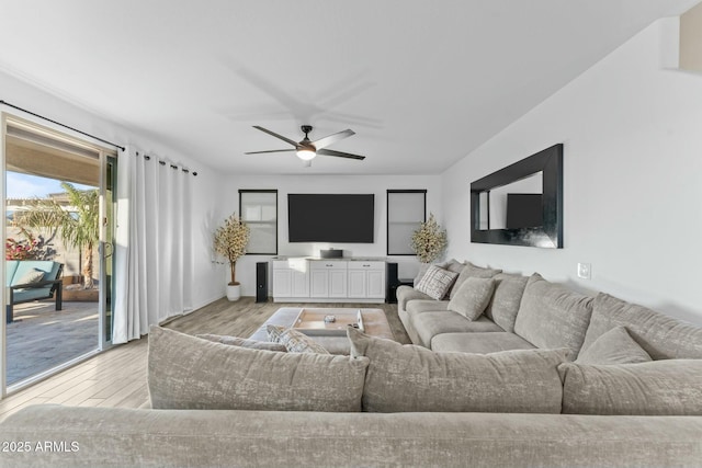 living room featuring ceiling fan and light hardwood / wood-style floors